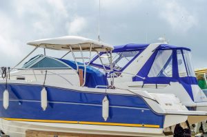 How should I protect the upholstery and interior of my boat during storage?